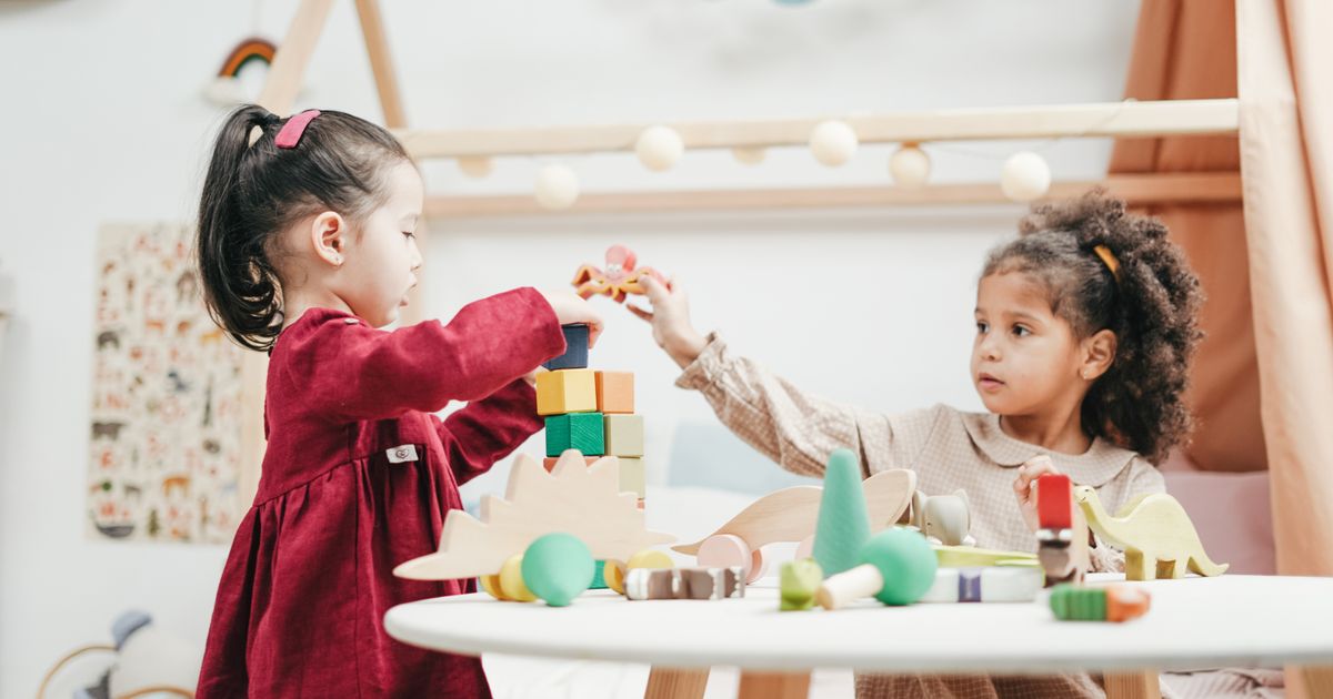 Young children playing with wooden learning toys