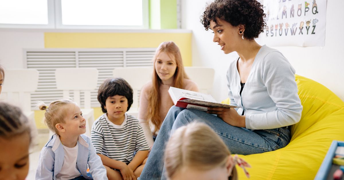 Parent and child reviewing schoolwork together at a table