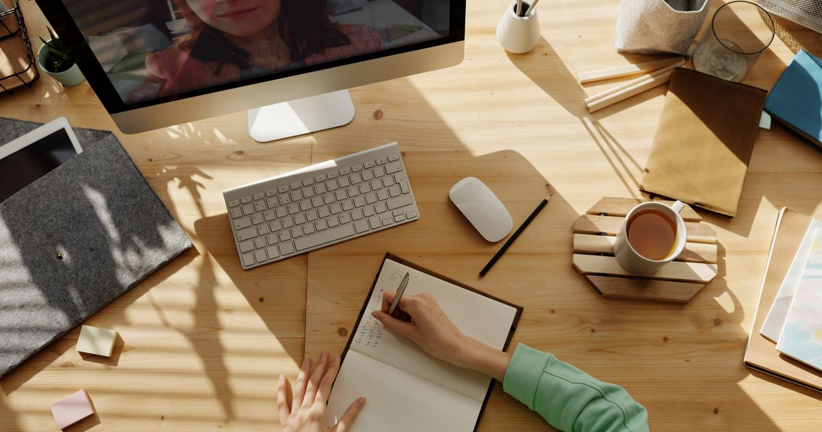 Adult tutoring a child at a desk