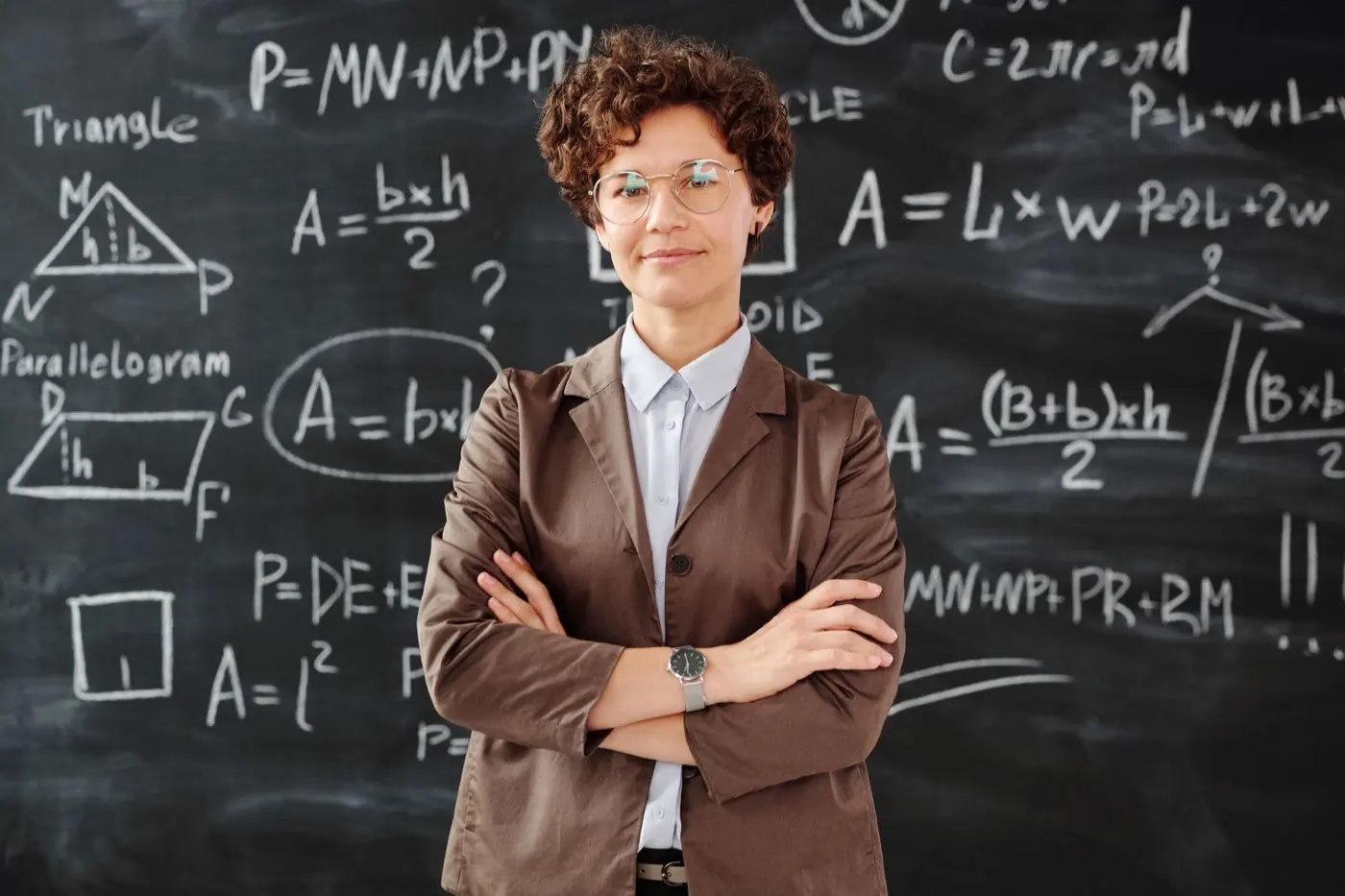 Education professional standing in front of a classroom chalkboard
