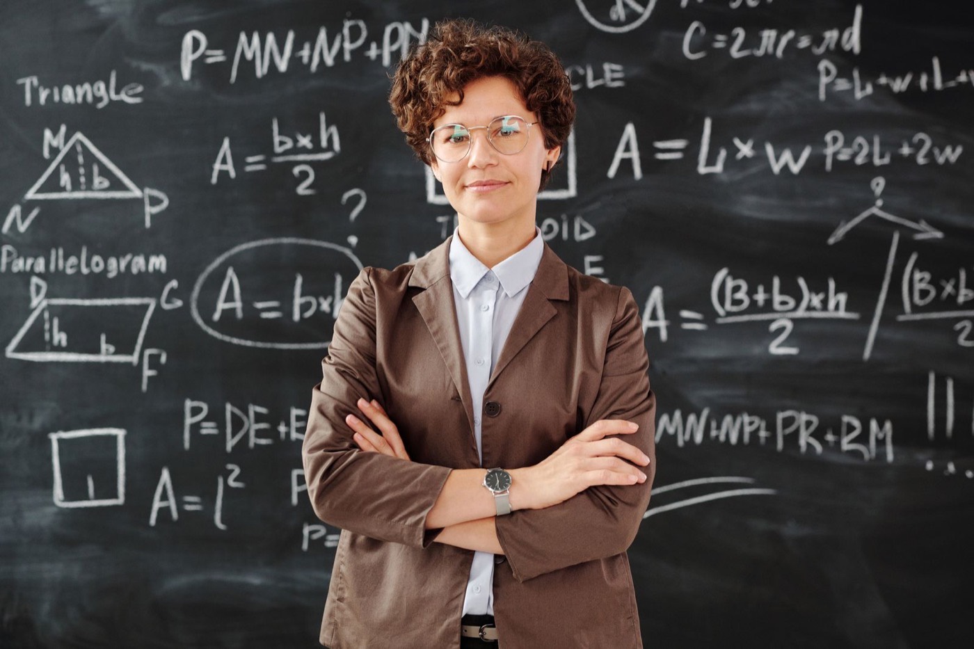 Education professional standing in front of a classroom chalkboard